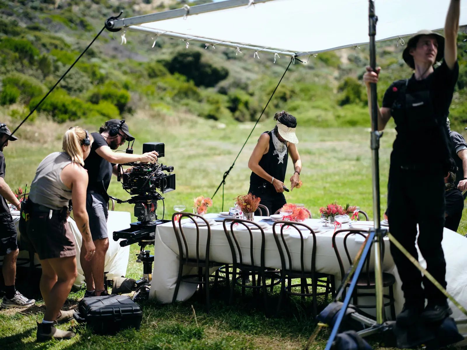 Local crew filming a long table scene outdoors on a South West film set