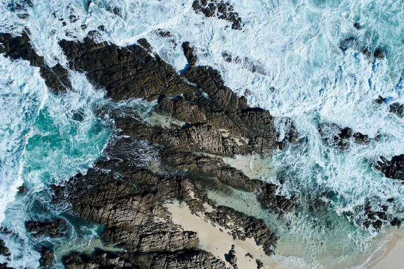 Overhead view of white water over dark granite, Honeycombs, Yallingup