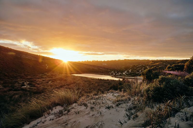 Sunset over the river mouth and coastal dunes, Margaret River mouth