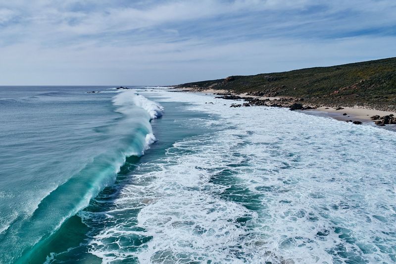 Wave peeling along the coast, Sugarloaf Rock, Cape Naturaliste